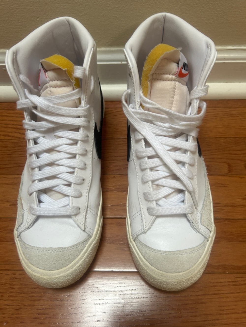 Nike White High-Top Sneakers with Black Swoosh and Yellow Tongue Accents